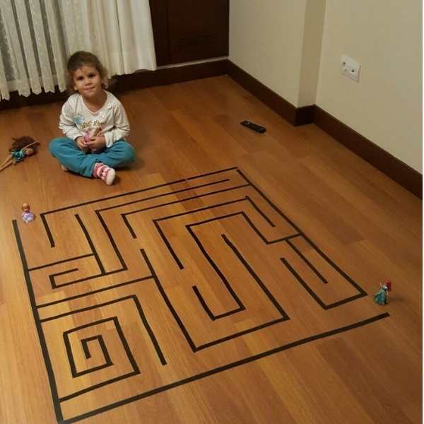 Toddler-beside-a-tape-maze.