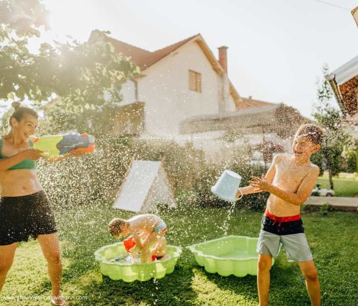 Mom-and-child-engaging-in-awater-balloon-fight-in-summer-bucket-list-ideas-for-faamilies