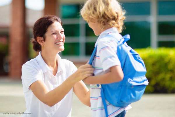 Mom-talking-to-her-child-in-a-school-compound-in-how-to-prepare-your-child-for-their-first-day-of-school.