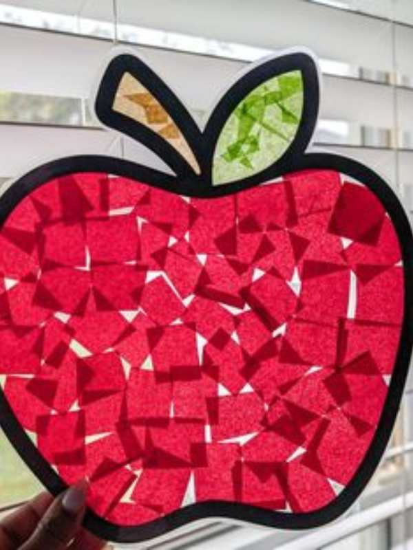 Red-apple-sun-catcher-displayed-on-a-glass-window.