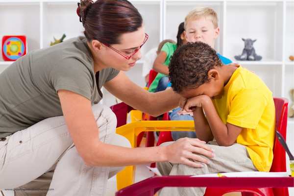 Teacher-petting-a-child-to-stop-crying-in-how-to-prepare-your-child-for-their-first-day-of-school.