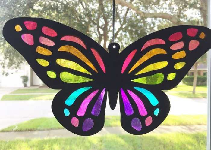 sun-catcher-butterfly-displayed-on-a-window-in-sun-catcher-crafts-for-kids.