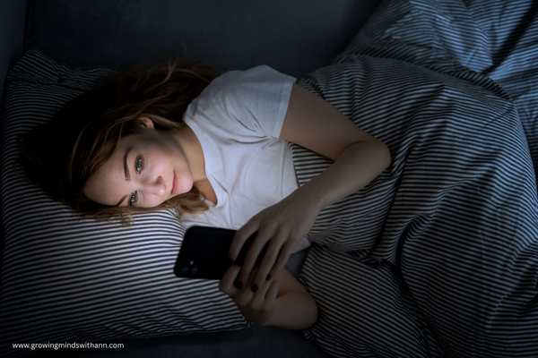 Woman-pressing-phone-while-on-the-bed-in-peaceful-morning-routine-every-mom-needs.