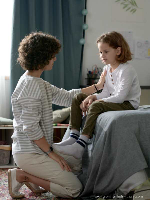 Mom-talking-to-her-child-sitting-on-a-bed-in-back-to-school-sleeping-schedule-for-kids.