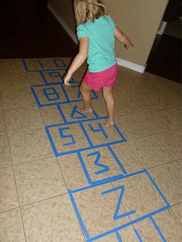 Child-playing-on-alphabet--hopscotch-in-fun-ways-to-teach-the-alphabet-to-preschoolers.