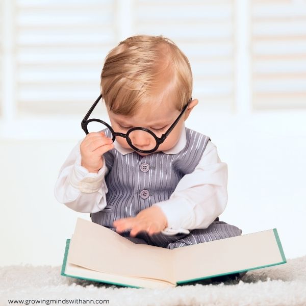 baby-holding-a-book-in-baby-photoshoot-ideas-at-home.