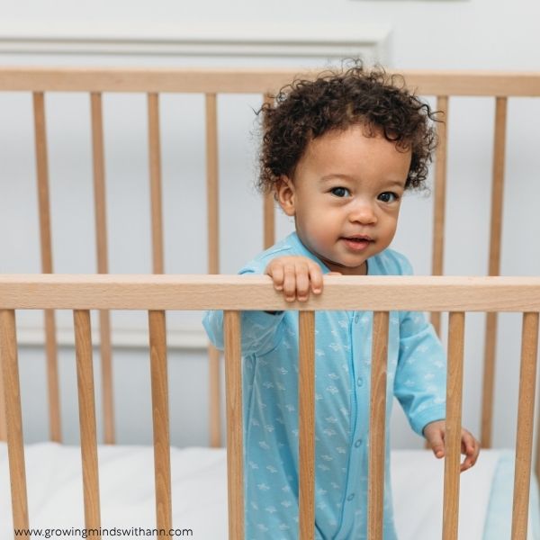 Baby-standing-in-a-crib.