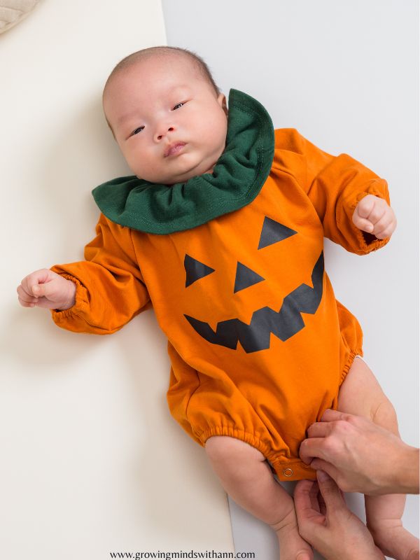 Baby-dressed-in-pumpkin--costume-in-baby's-first-halloween-costume-ideas.