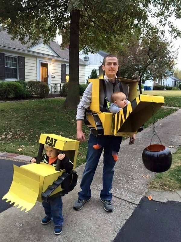Dad-carrying--baby-dressed-in-bulldozer-wrecking-ball-costume.