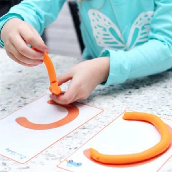 Child-using-playdough-to-form-the-letter-c-in-fun-ways-to-teach-the-alphabet-to-preschoolers.