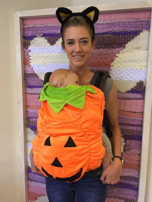 Mom-carrying-baby-in-pumpkin-patch-costume.