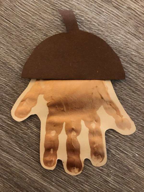 Handprint-acorn-on-a-yellow-paper. 