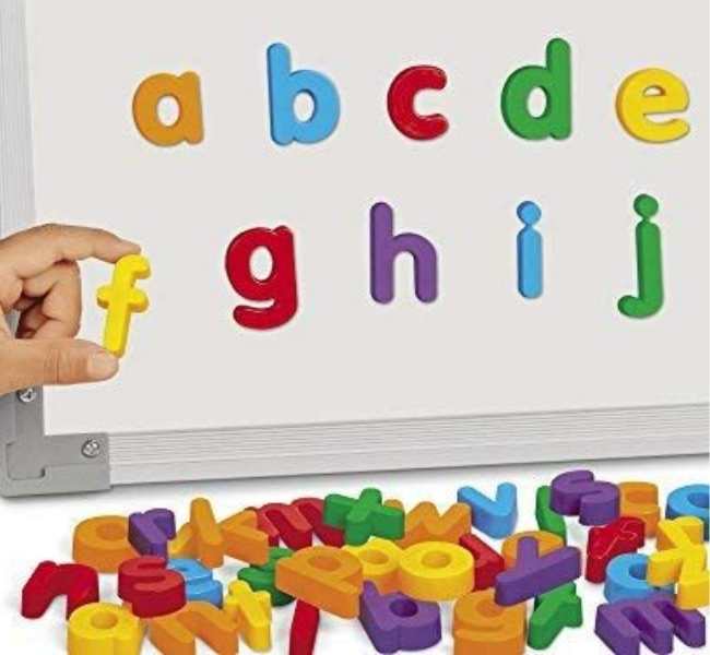 Hand-sticking-magnetic-letters-on-magnetic-white-board.