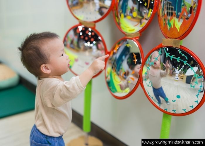 Baby-playing-with-a-mirror.