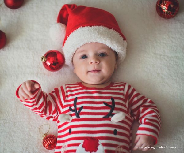 Baby-wearing-simple-Christmas-cloth-while-lying-on-the-bed-in-Christmas-traditions-to-start-with-your-baby.