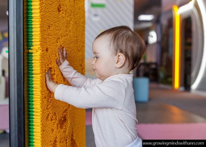 Baby-touching-a-rough-surface-in-simple-activities-to-do-with-your-baby-at-home.