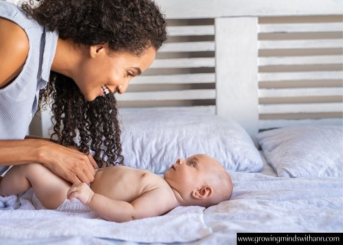 Mom-talking-to-baby-while-changing-diaper-in-simple-activities-to-do-with-your-baby-at-home.