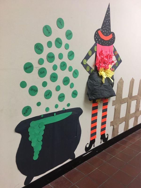 Witch-portion-station-designed-with-scarecrow-big-pot-and-black-green-orange-and-yellow-colors.