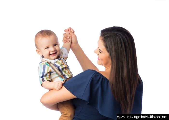 Mom-dancing-with-baby-on-her-hand-in-simple-activities-to-do-wit-your-baby-at-home.