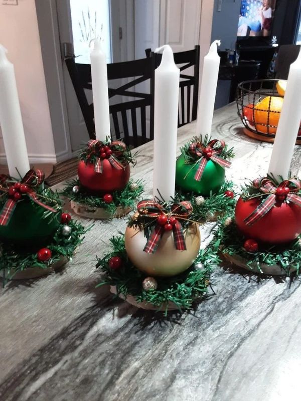 Five-Christmas-candle-holder-with-white-candle-on-each-one.