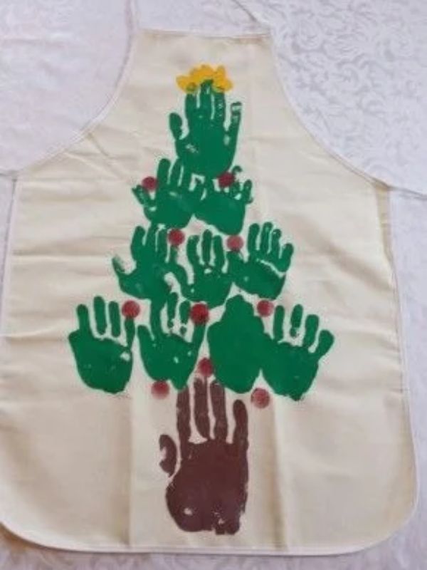White-apron-with-several-green-handprint-aand-one-brown-handprint-in-Christmas-keepsakes-kids-can-maake-for-their-parents.
