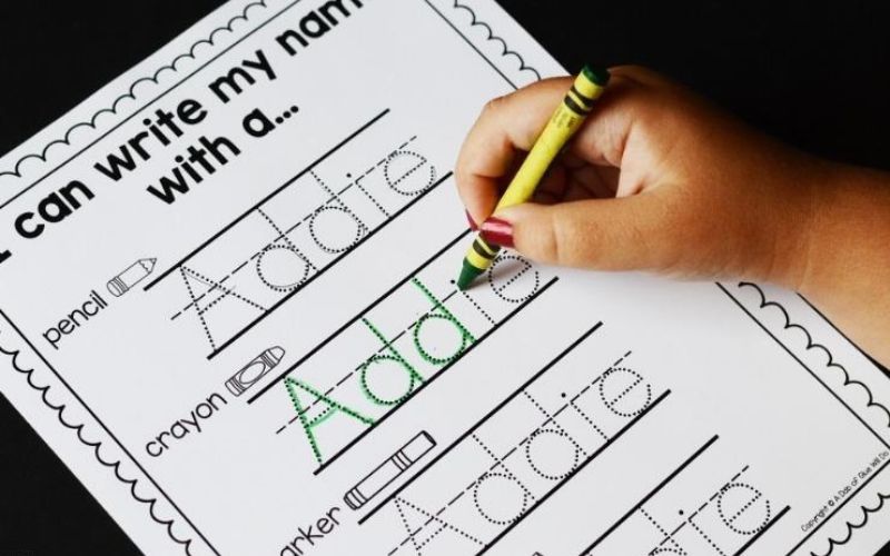 Hand-tracing-the-name-Addie-in-name-activities-for-preschoolers.