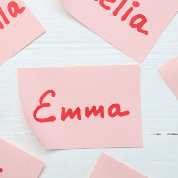 Different-names-written-on-a-pink-cardboard-with-red-marker-in-name-activities-for-preschoolers.