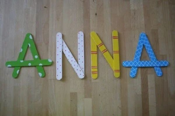 Anna-designed-with-white-yellow-blue-and-green-popsicle-stick-in-name-activities-for-preschoolers.