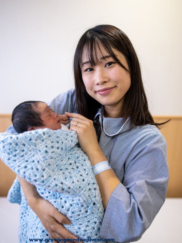 Mom-wearing-blue-shirt-carrying-baby-wrapped-with-blue-cloth-in-postpartum-wardrobe-essentials-every-mom-needs.
